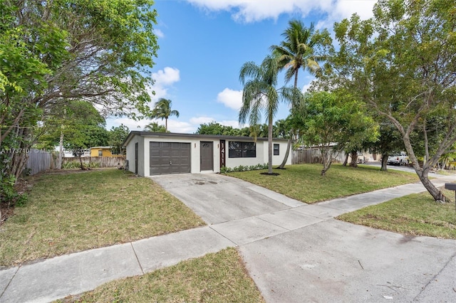 ranch-style house with a garage and a front lawn