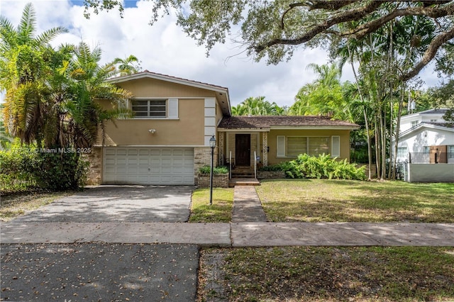 view of front of home with a garage and a front lawn