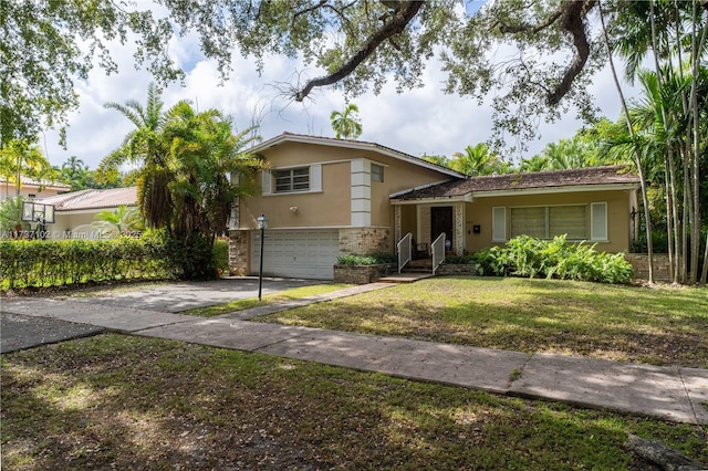 split level home with a garage and a front lawn