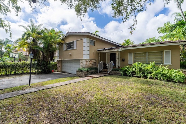 tri-level home with a garage and a front lawn