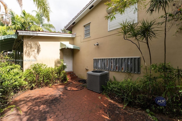 rear view of house with central AC unit