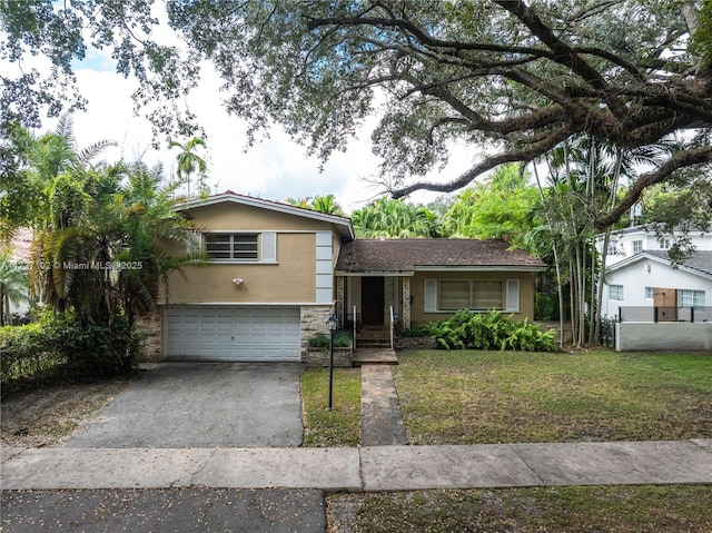 tri-level home featuring a garage and a front yard