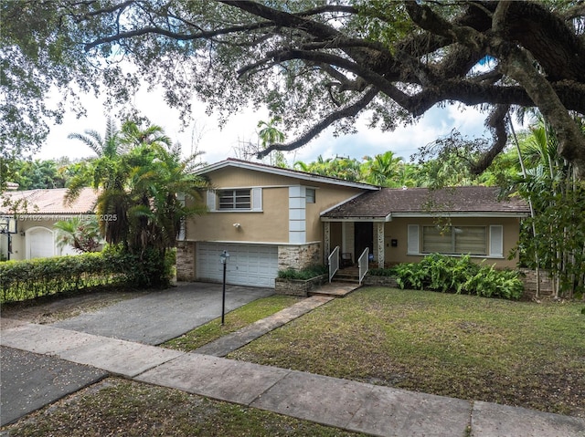 tri-level home with a garage and a front lawn