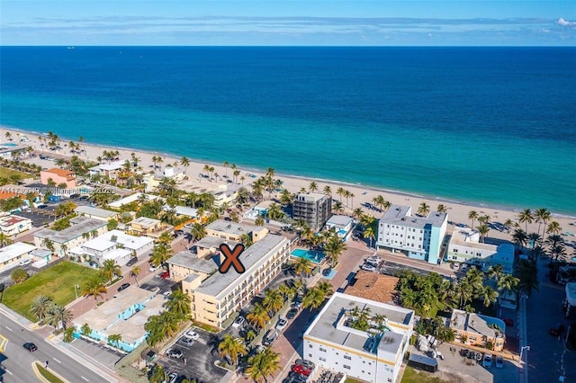 birds eye view of property featuring a water view and a view of the beach