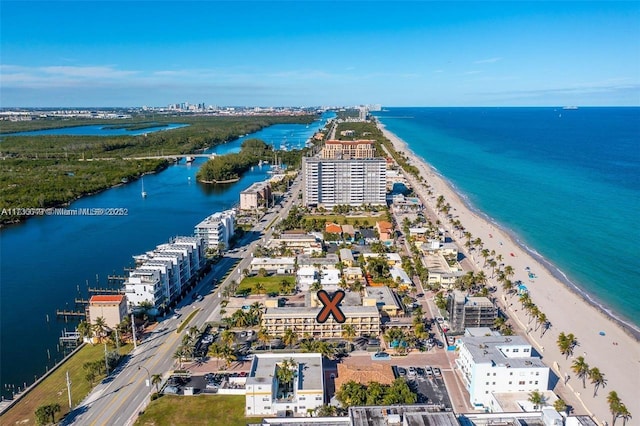 birds eye view of property featuring a beach view and a water view