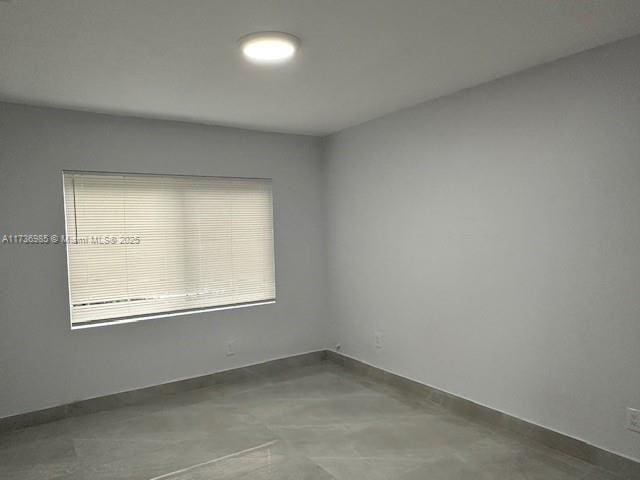 empty room with concrete flooring