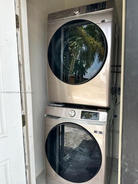 laundry area with stacked washer and clothes dryer