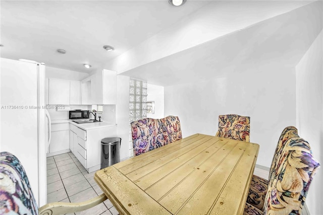 tiled dining area featuring sink