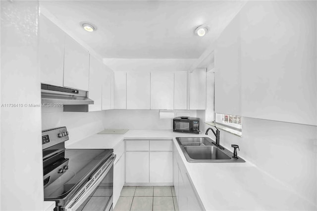 kitchen featuring light tile patterned flooring, stainless steel electric stove, sink, and white cabinets