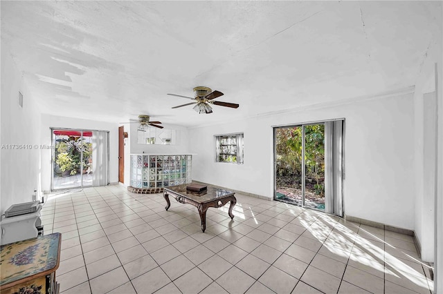 living room featuring ceiling fan, a healthy amount of sunlight, and light tile patterned floors