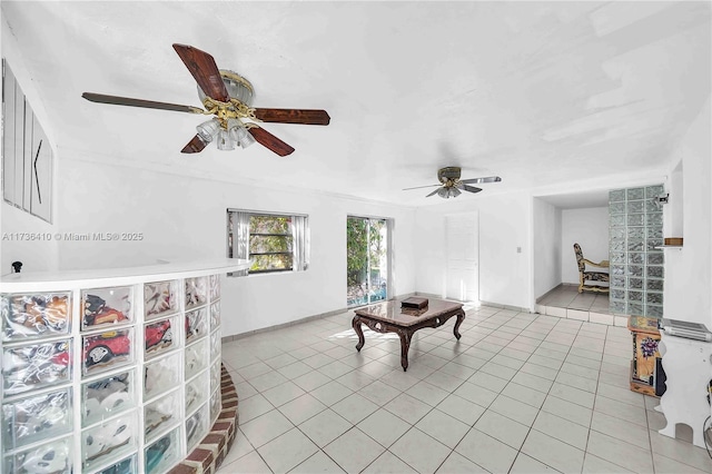 tiled living room with ceiling fan