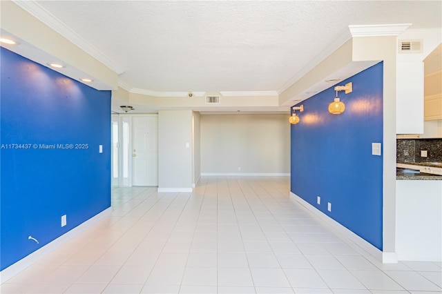 unfurnished room featuring crown molding, light tile patterned flooring, and a textured ceiling