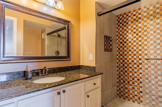 bathroom featuring vanity and a tile shower