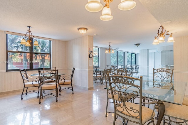 dining space featuring an inviting chandelier and a textured ceiling