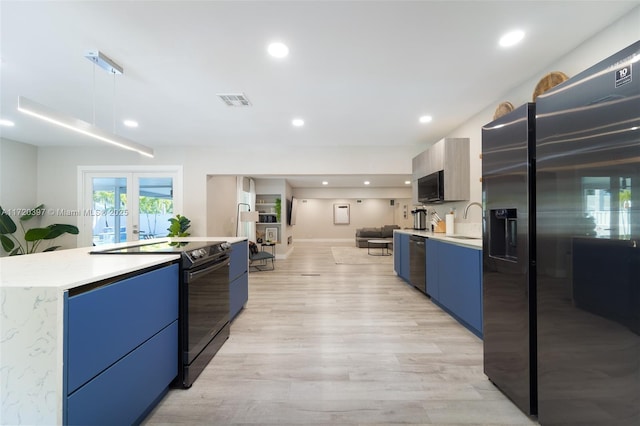 kitchen with french doors, sink, decorative light fixtures, light hardwood / wood-style flooring, and appliances with stainless steel finishes