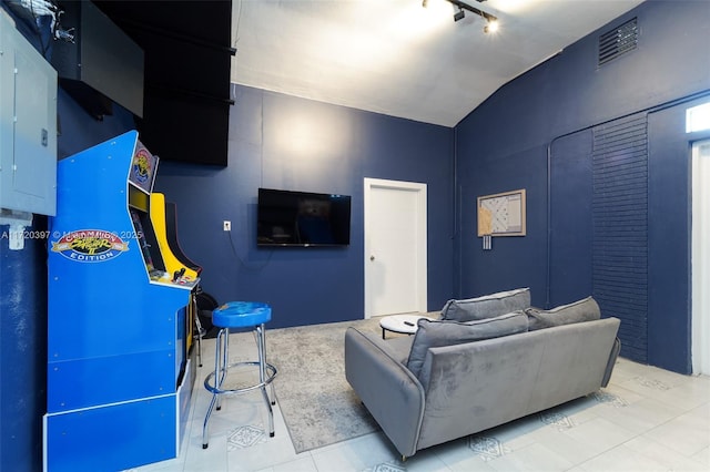 living room with vaulted ceiling, electric panel, and rail lighting