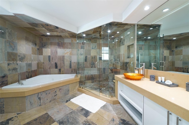 bathroom featuring tile walls, vanity, and shower with separate bathtub