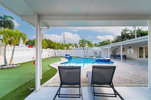 view of pool with an in ground hot tub and a patio