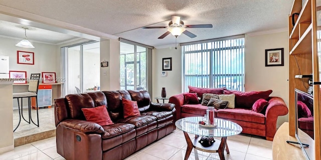 tiled living room featuring ceiling fan, ornamental molding, and a textured ceiling