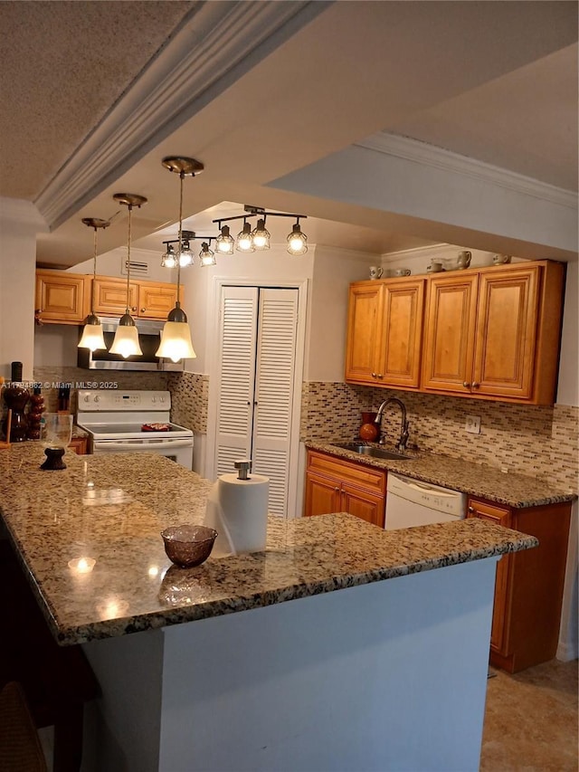 kitchen with pendant lighting, white appliances, crown molding, and sink