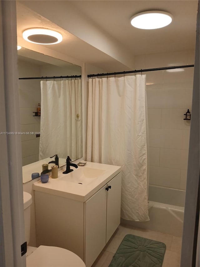 full bathroom featuring tile patterned flooring, vanity, toilet, and shower / bath combo with shower curtain