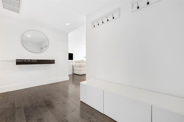 corridor with dark hardwood / wood-style flooring