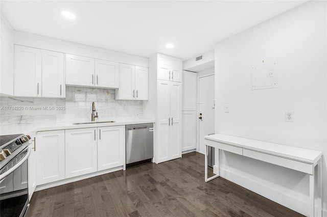 kitchen with appliances with stainless steel finishes, dark hardwood / wood-style floors, sink, and white cabinets