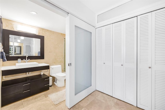 bathroom featuring tile patterned floors, vanity, and toilet