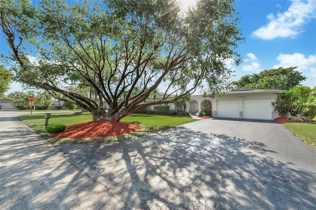 view of front of property with a garage and a front yard