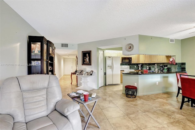 tiled living room featuring a textured ceiling