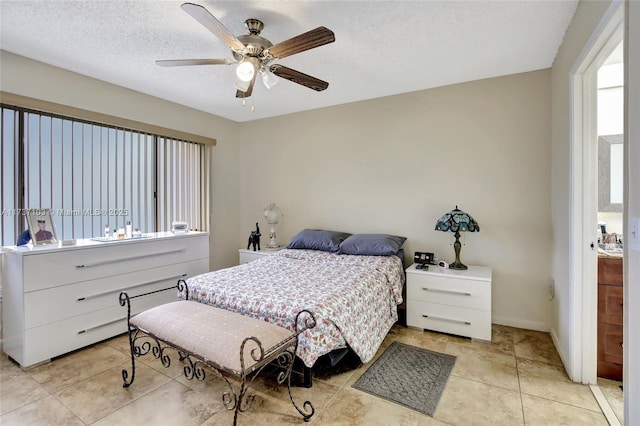 bedroom with ceiling fan and a textured ceiling