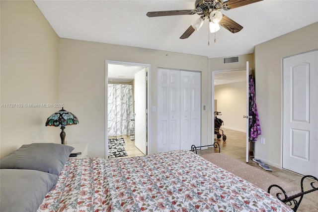 bedroom with ceiling fan, ensuite bath, a closet, and a textured ceiling