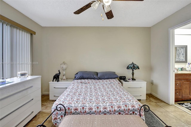 tiled bedroom with ceiling fan, connected bathroom, and a textured ceiling