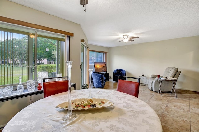 dining space featuring ceiling fan, a textured ceiling, and light tile patterned floors