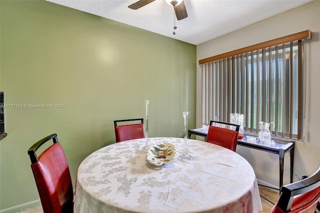 dining room featuring ceiling fan and a textured ceiling