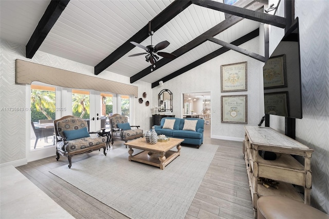 living room featuring french doors, beamed ceiling, wood finished floors, and wallpapered walls