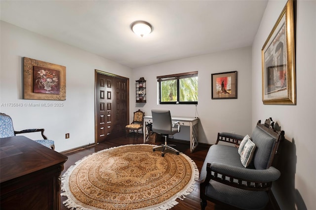 home office featuring baseboards and dark wood-type flooring