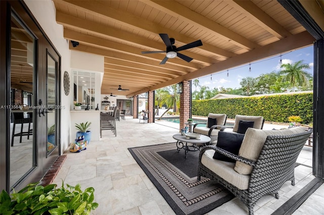 view of patio featuring a fenced in pool and ceiling fan