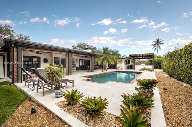 view of swimming pool featuring a patio area, a fenced backyard, a ceiling fan, and a pergola