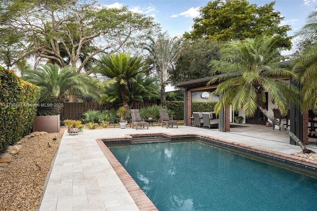 view of pool with a fenced in pool, a patio, and fence