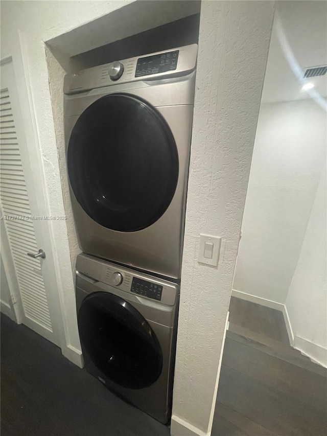 washroom with stacked washer and dryer