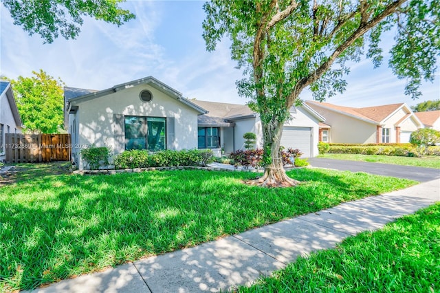 single story home with a garage and a front lawn