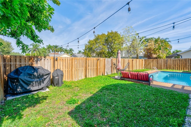 view of yard with a fenced in pool