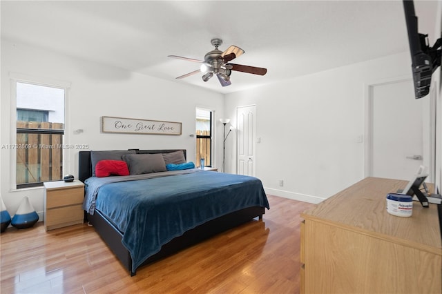 bedroom featuring light hardwood / wood-style floors, a closet, and ceiling fan