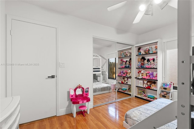 bedroom featuring ceiling fan, hardwood / wood-style floors, and a closet