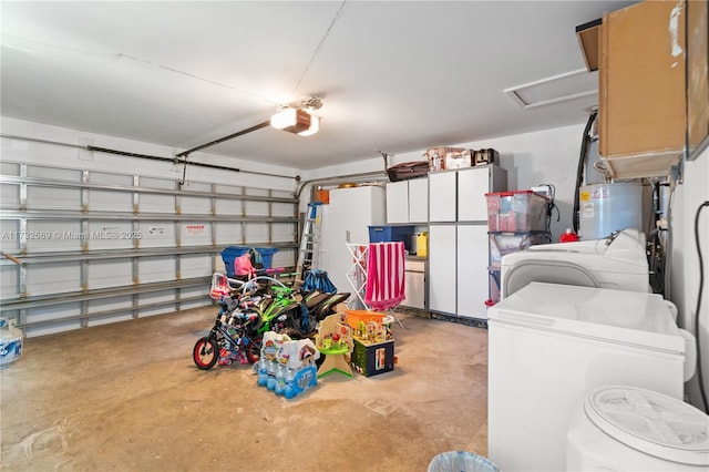 garage featuring a garage door opener, electric water heater, and independent washer and dryer