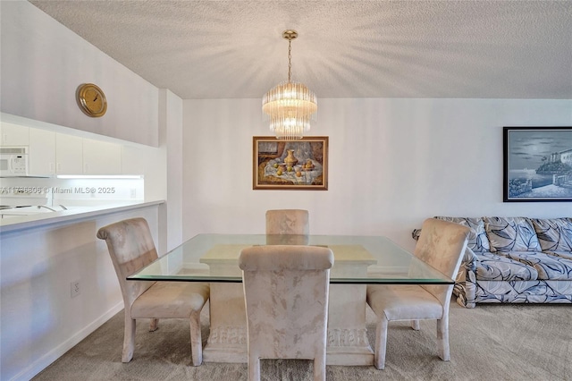 carpeted dining space with an inviting chandelier and a textured ceiling