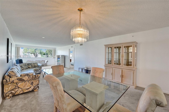 dining area featuring light carpet, a textured ceiling, and an inviting chandelier