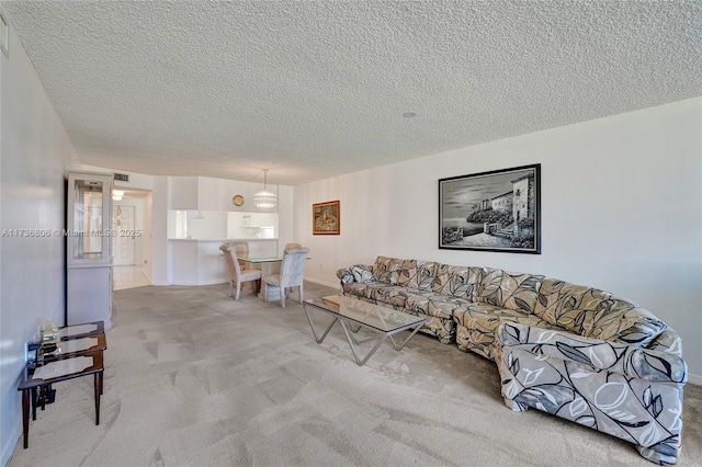 living room with light colored carpet and a textured ceiling