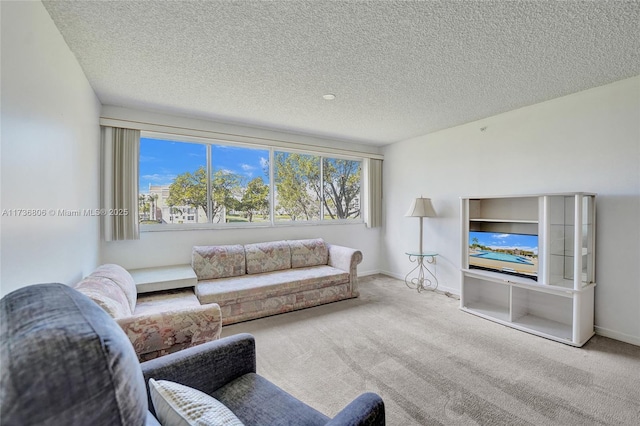 living room featuring carpet flooring, a textured ceiling, and a wealth of natural light